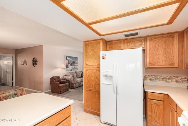 kitchen with light tile patterned flooring and white appliances