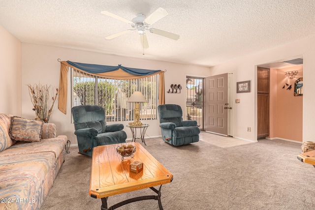 carpeted living room with ceiling fan and a textured ceiling