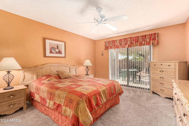 carpeted bedroom with access to exterior, ceiling fan, and a textured ceiling