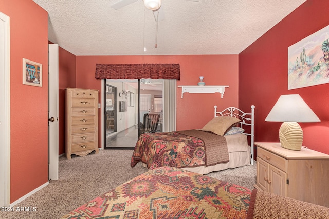 carpeted bedroom featuring ceiling fan and a textured ceiling