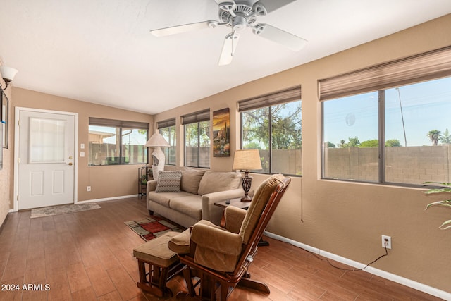 living room with hardwood / wood-style flooring, ceiling fan, and lofted ceiling