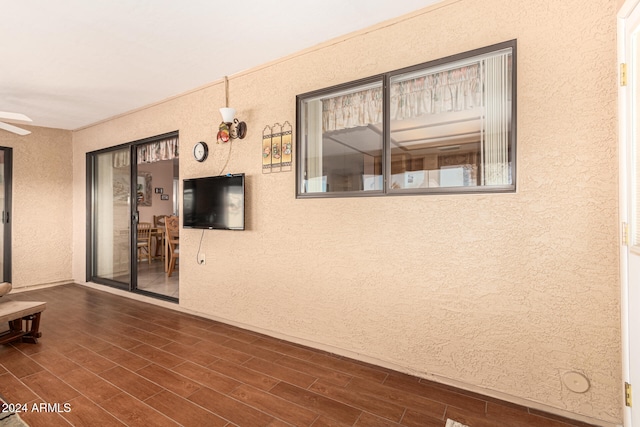 unfurnished room featuring ceiling fan and dark hardwood / wood-style flooring