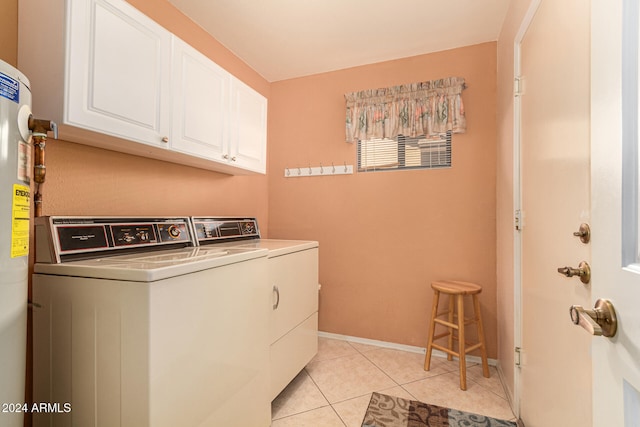 laundry area with washer and clothes dryer, light tile patterned flooring, and cabinets