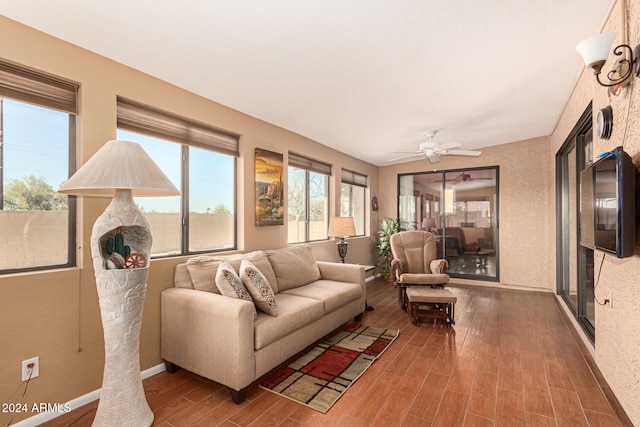 living room featuring hardwood / wood-style floors and ceiling fan