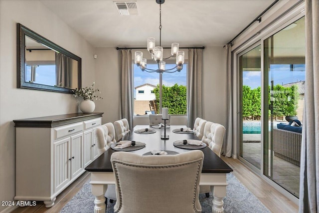 dining room featuring an inviting chandelier and light hardwood / wood-style flooring