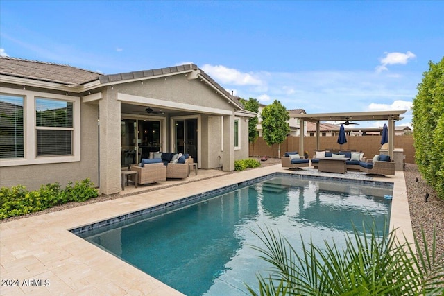 view of pool with outdoor lounge area, ceiling fan, and a patio area