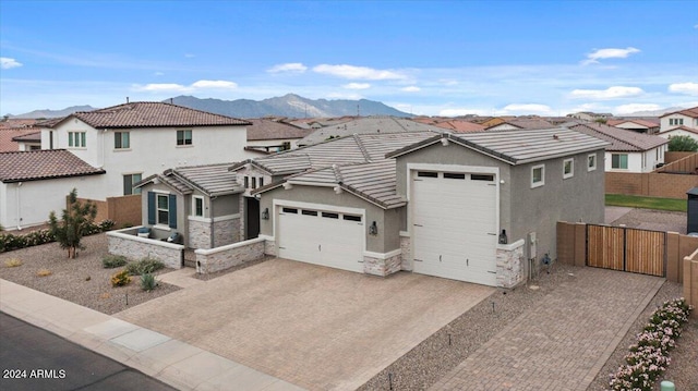 view of front facade with a mountain view and a garage