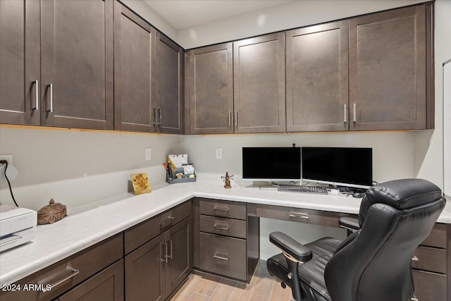 office space with light hardwood / wood-style floors and built in desk