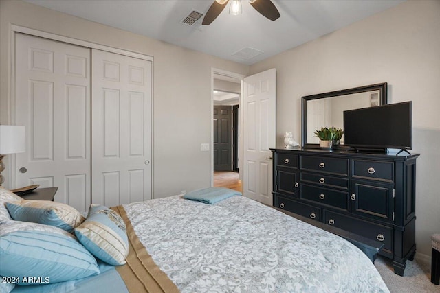 carpeted bedroom with a closet and ceiling fan