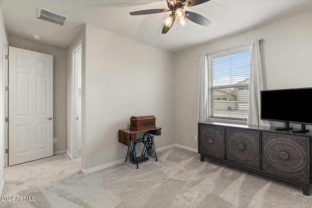 interior space featuring light carpet and ceiling fan