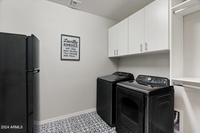 laundry area with cabinets and washer and clothes dryer