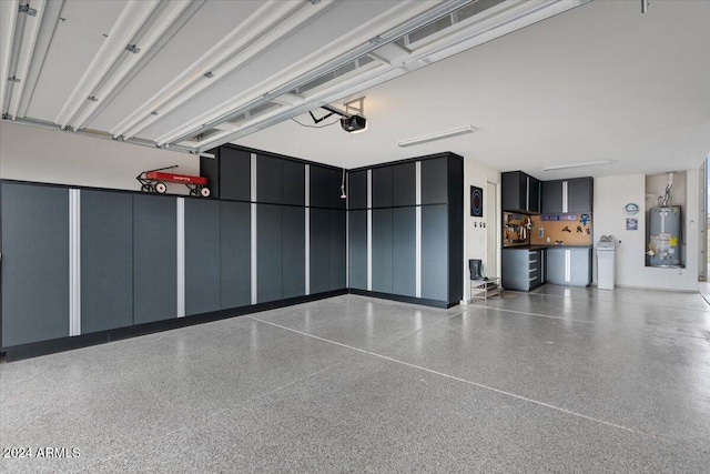 garage featuring a garage door opener and water heater