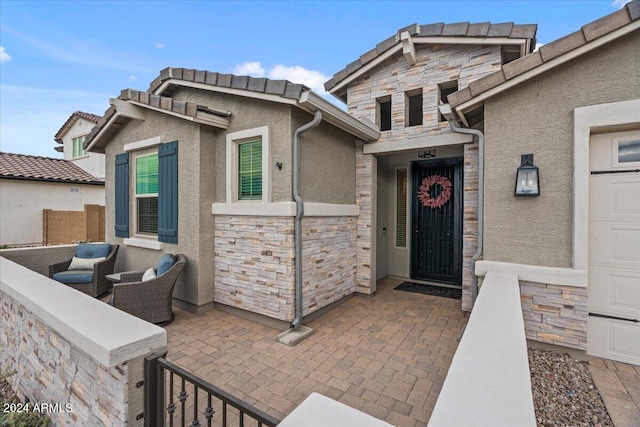 view of exterior entry featuring a patio