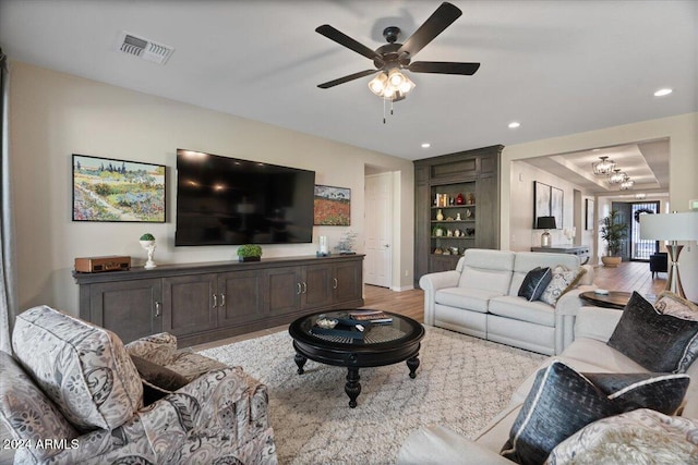 living room featuring ceiling fan and light hardwood / wood-style floors