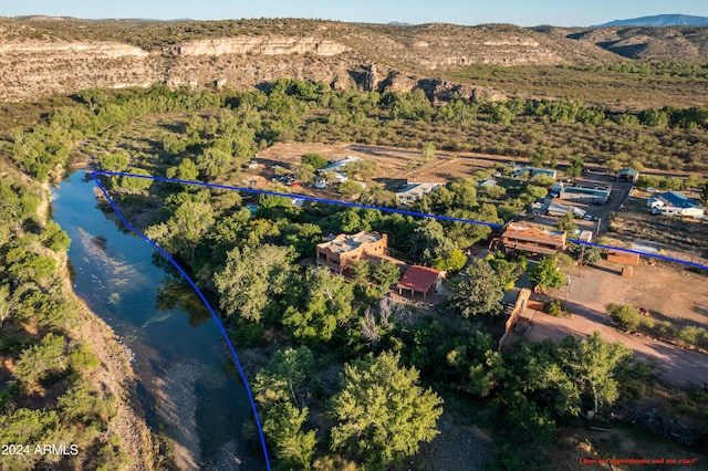 bird's eye view with a water and mountain view