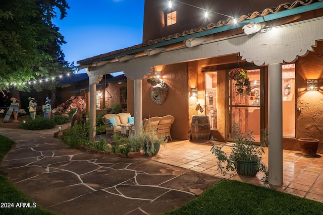 patio terrace at dusk featuring outdoor lounge area