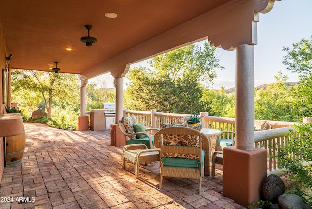 view of patio / terrace with grilling area, ceiling fan, and an outdoor kitchen