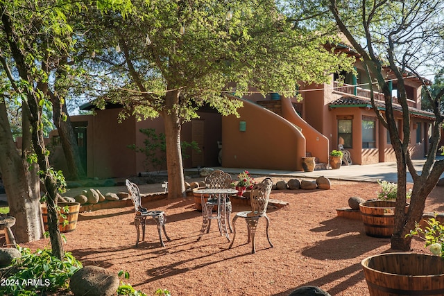 view of patio featuring a balcony