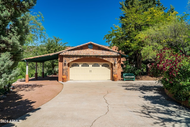 view of front of property featuring a garage and a carport