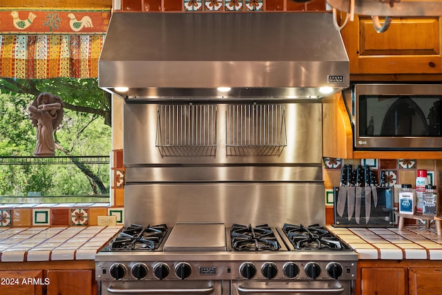 kitchen featuring tile counters and appliances with stainless steel finishes