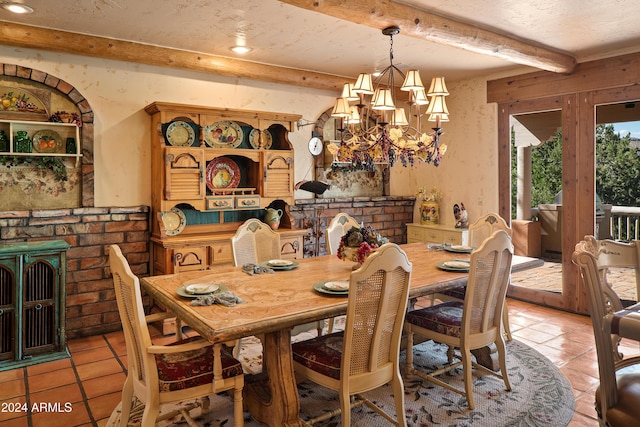 dining room with beamed ceiling, light tile patterned floors, a fireplace, and an inviting chandelier