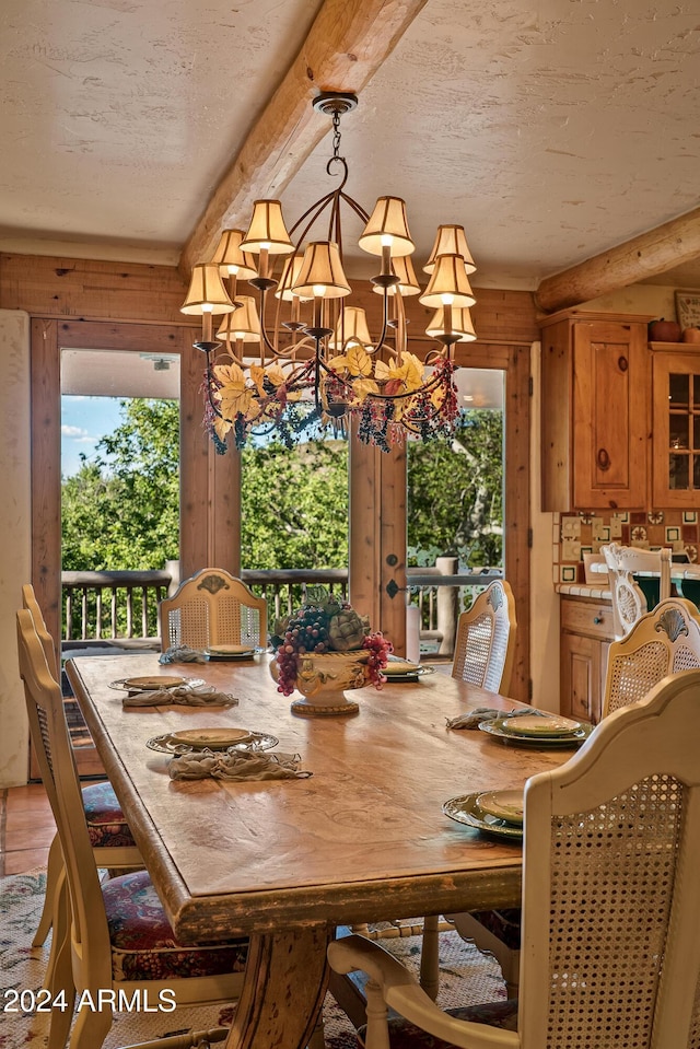 dining area featuring a textured ceiling and a notable chandelier