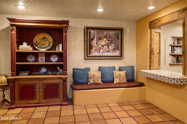 sitting room featuring light tile patterned floors and a textured ceiling