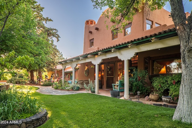 rear view of property featuring a yard