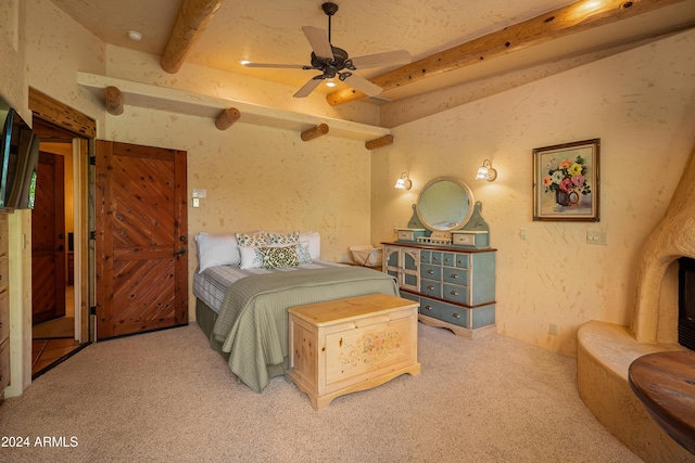 carpeted bedroom with ceiling fan and beam ceiling