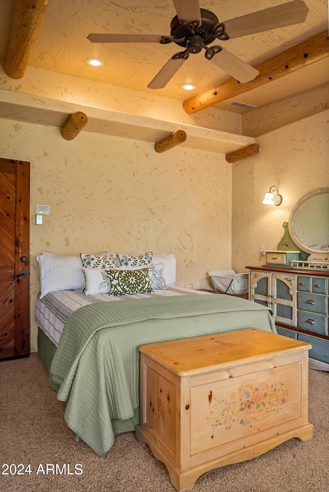 carpeted bedroom with beam ceiling and ceiling fan