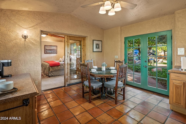 dining room featuring tile patterned floors, ceiling fan, french doors, and lofted ceiling