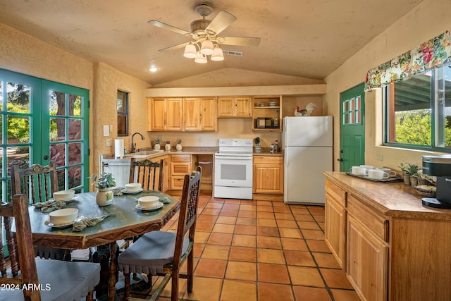 kitchen featuring white appliances, ceiling fan, sink, light tile patterned floors, and lofted ceiling