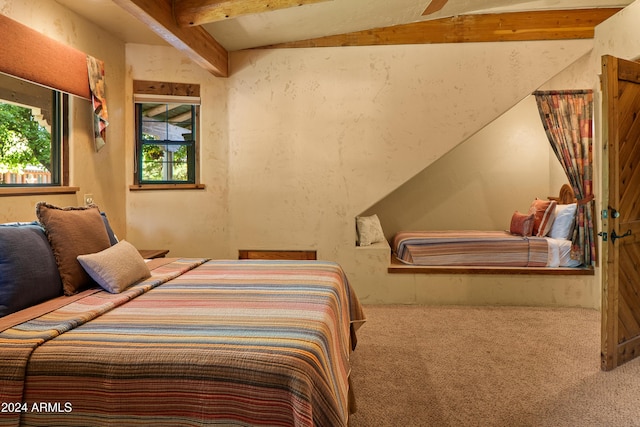 bedroom featuring carpet flooring and beamed ceiling