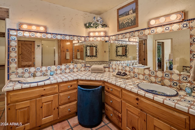 bathroom with tile patterned flooring, vanity, and an enclosed shower