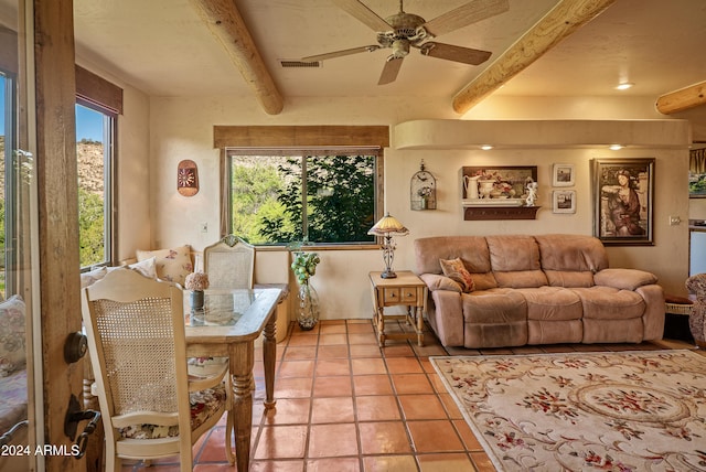 tiled living room featuring ceiling fan and beam ceiling