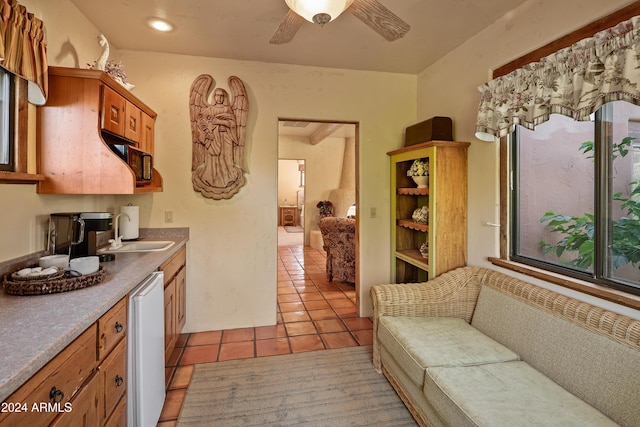 kitchen featuring dishwasher, light tile patterned flooring, sink, and ceiling fan