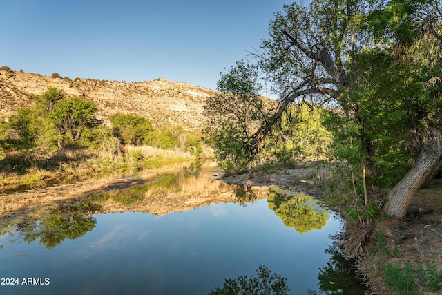 birds eye view of property featuring a water and mountain view