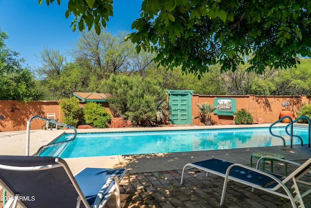 view of swimming pool featuring a patio area