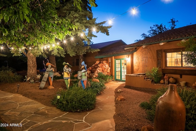 back house at dusk with french doors