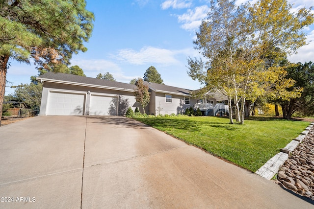 view of front of home with a front lawn and a garage