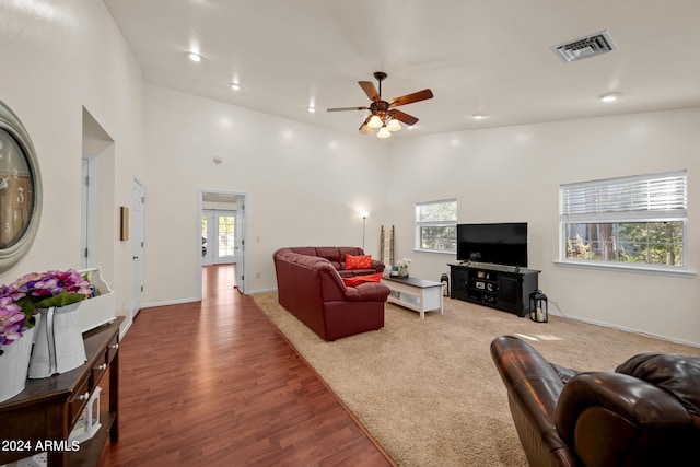 living room with hardwood / wood-style floors, a healthy amount of sunlight, high vaulted ceiling, and ceiling fan