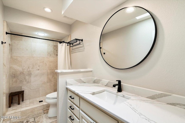 full bath featuring vanity, toilet, recessed lighting, and a tile shower