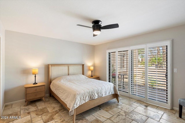 bedroom with stone tile floors, ceiling fan, baseboards, and access to outside