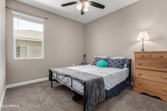 carpeted bedroom with ceiling fan and baseboards