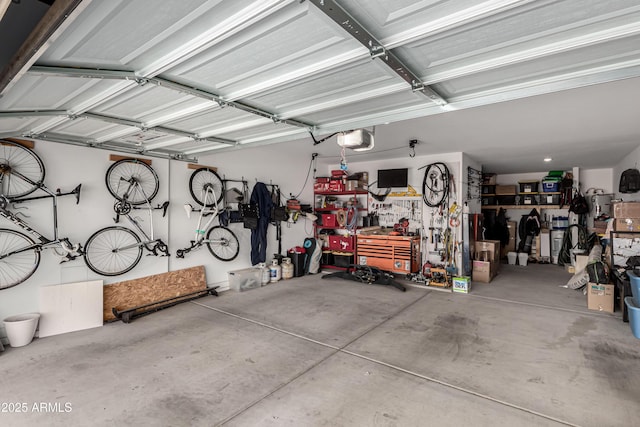 garage with a workshop area and a garage door opener