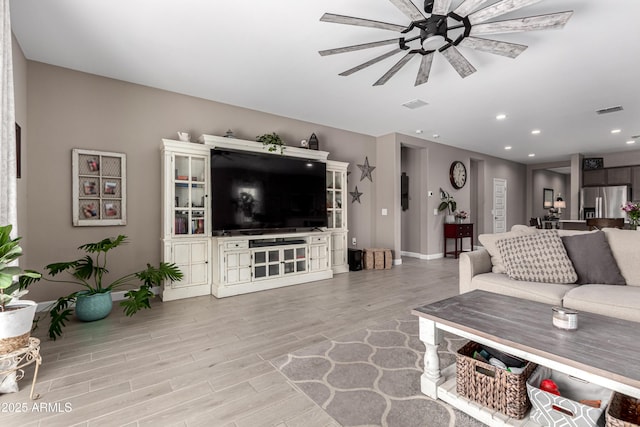 living area with recessed lighting, visible vents, ceiling fan, and wood finished floors