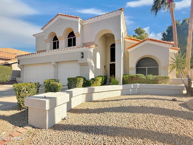 mediterranean / spanish home featuring a garage