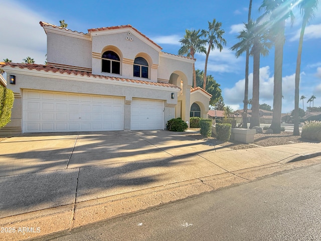 mediterranean / spanish house featuring a garage