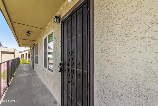 461 W Holmes Ave Unit 323, Mesa, AZ 85210 - property entrance featuring a balcony and stucco siding