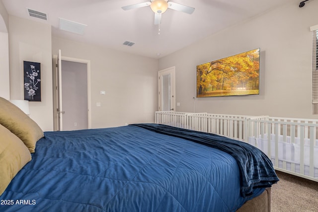 carpeted bedroom featuring visible vents and a ceiling fan